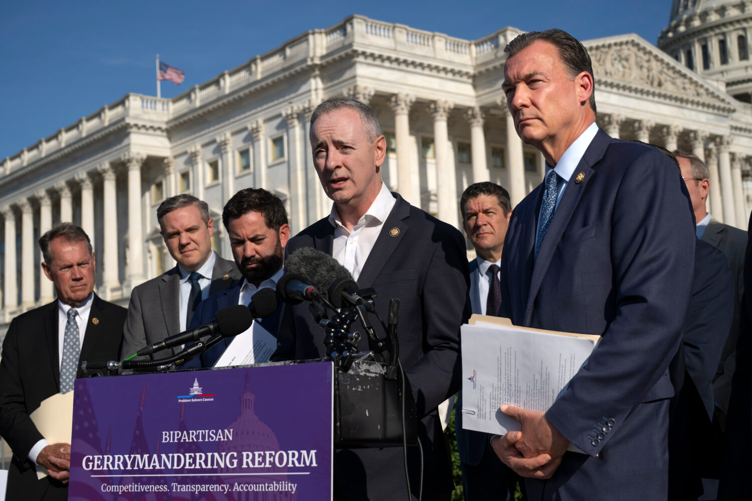 Rep. Brian Fitzpatrick, R-Pa., center, and Rep. Tom Suozzi, D-N.Y., right, talk to reporters about ...