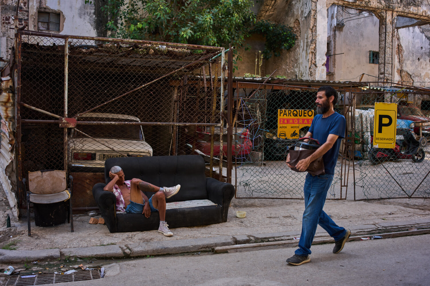 A man rests on a sofa on a street in Havana, Cuba, Thursday, Aug. 27, 2026. (AP Photo/Ramon Espinos...