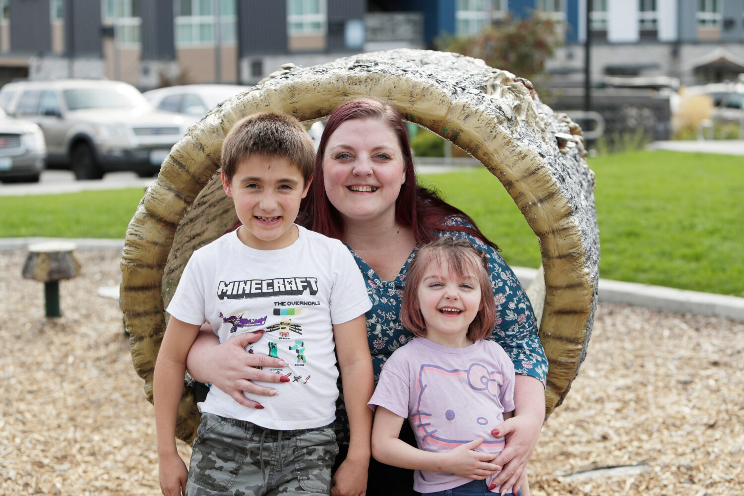 Cassie Reed, center, sits for a photograph with her son Kian Reed, left, and daughter Evie Reed out...