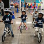 A childhood rite moves indoors as kindergartners learn to ride bikes in school gyms