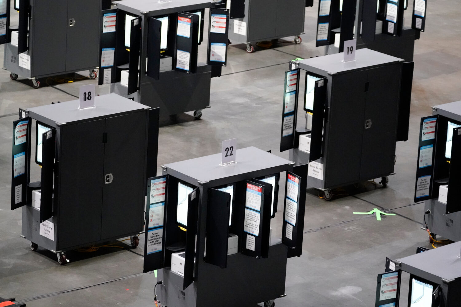 FILE - Voting machines fill the floor for early voting at State Farm Arena, Oct. 12, 2020, in Atlan...