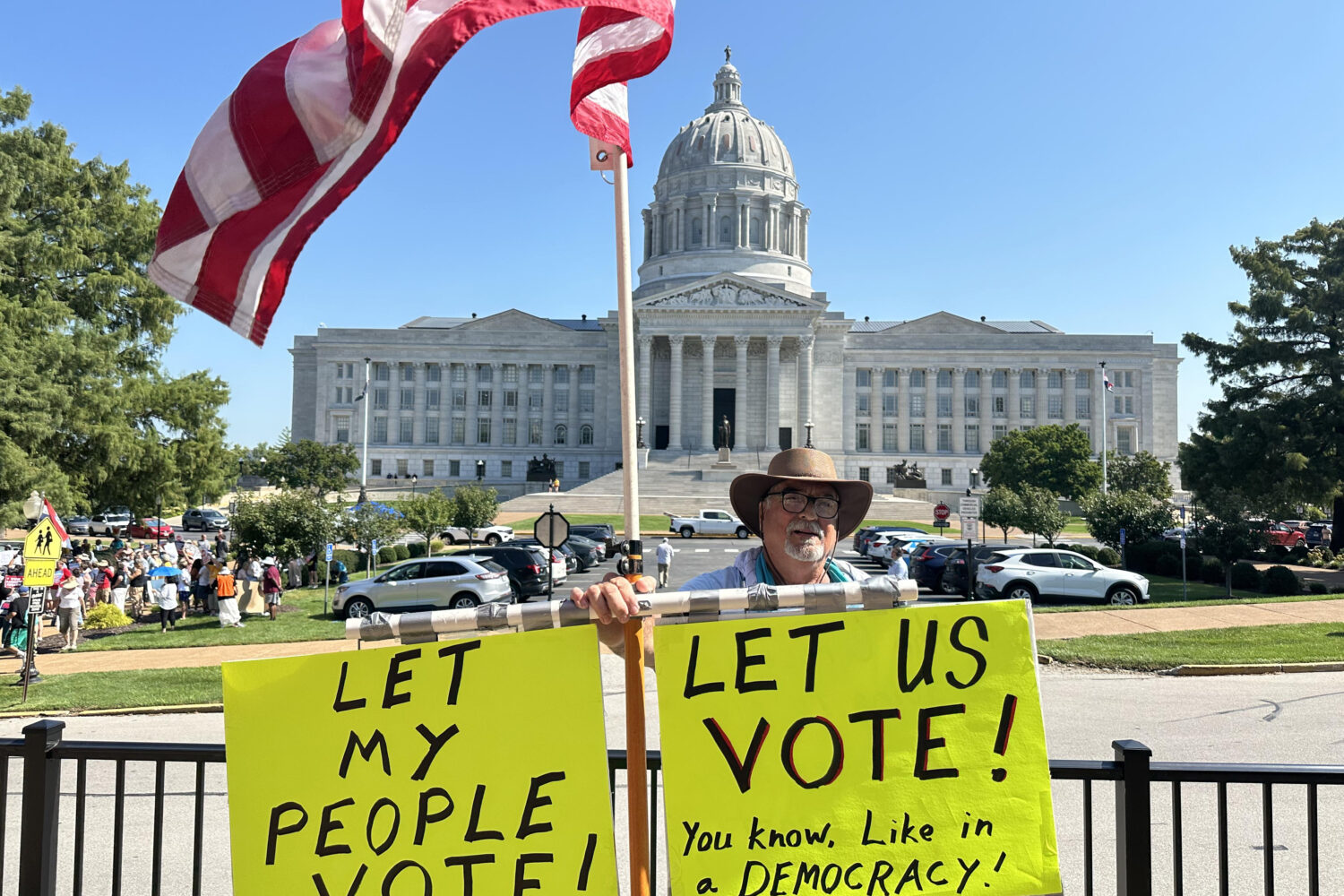 In this photo taken with a smartphone, Steve Dakopolos demonstrates in front of the state Capitol i...