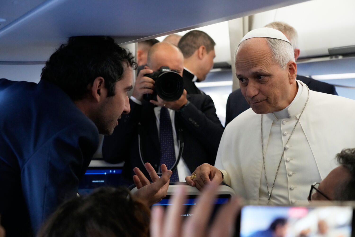 Pope Leo XIV talks to journalists aboard the papal flight from Rome to Paris, Friday, Sept. 25, 202...