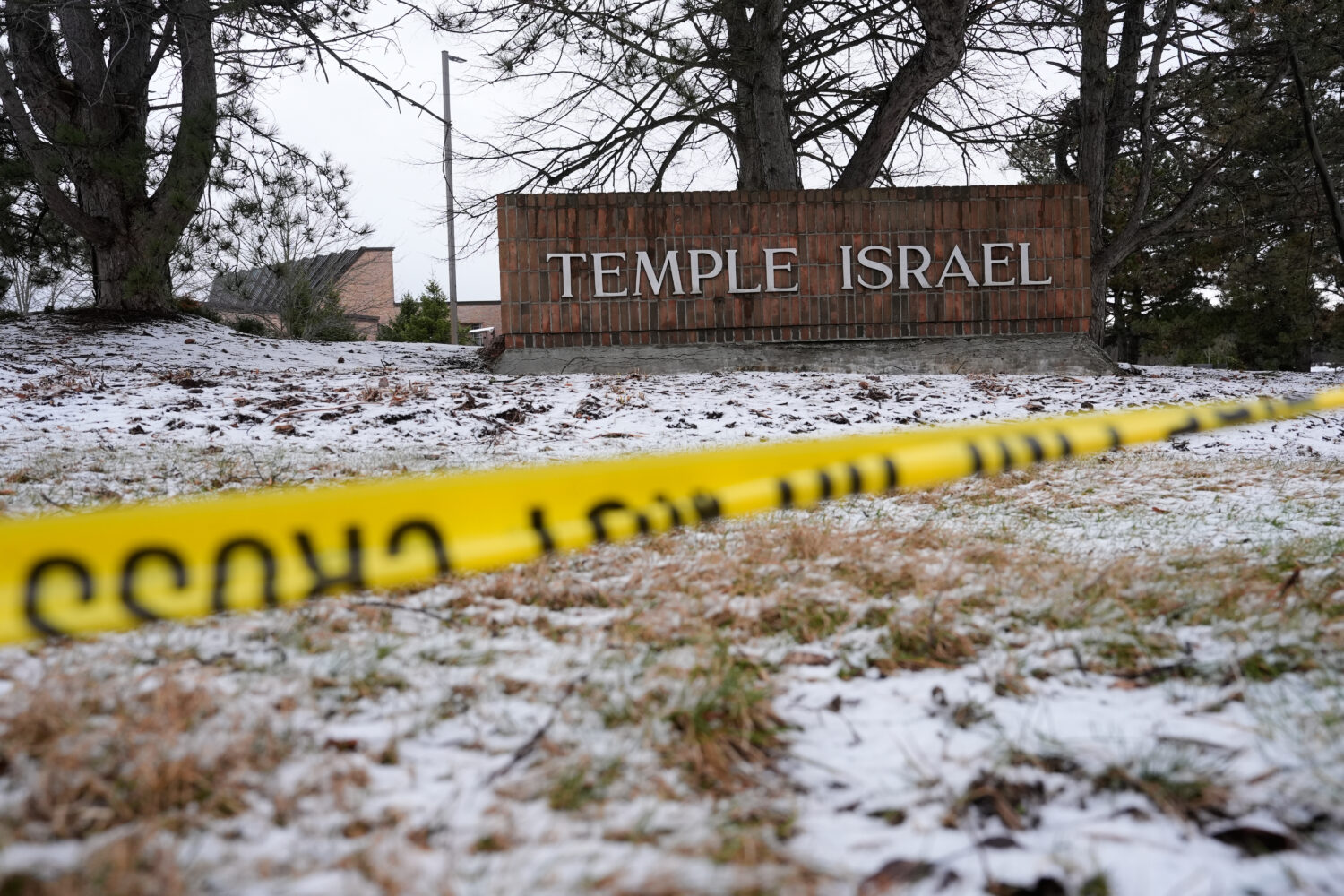 FILE - Police tape hangs outside the Temple Israel synagogue on March 13, 2026, in West Bloomfield ...