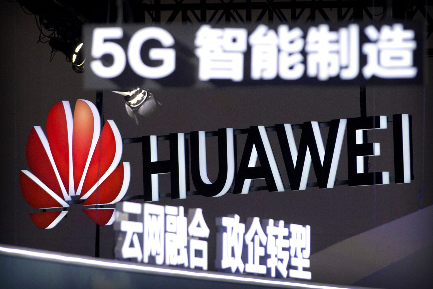 FILE - Signs promoting 5G wireless technology from Chinese technology firm Huawei are displayed at ...