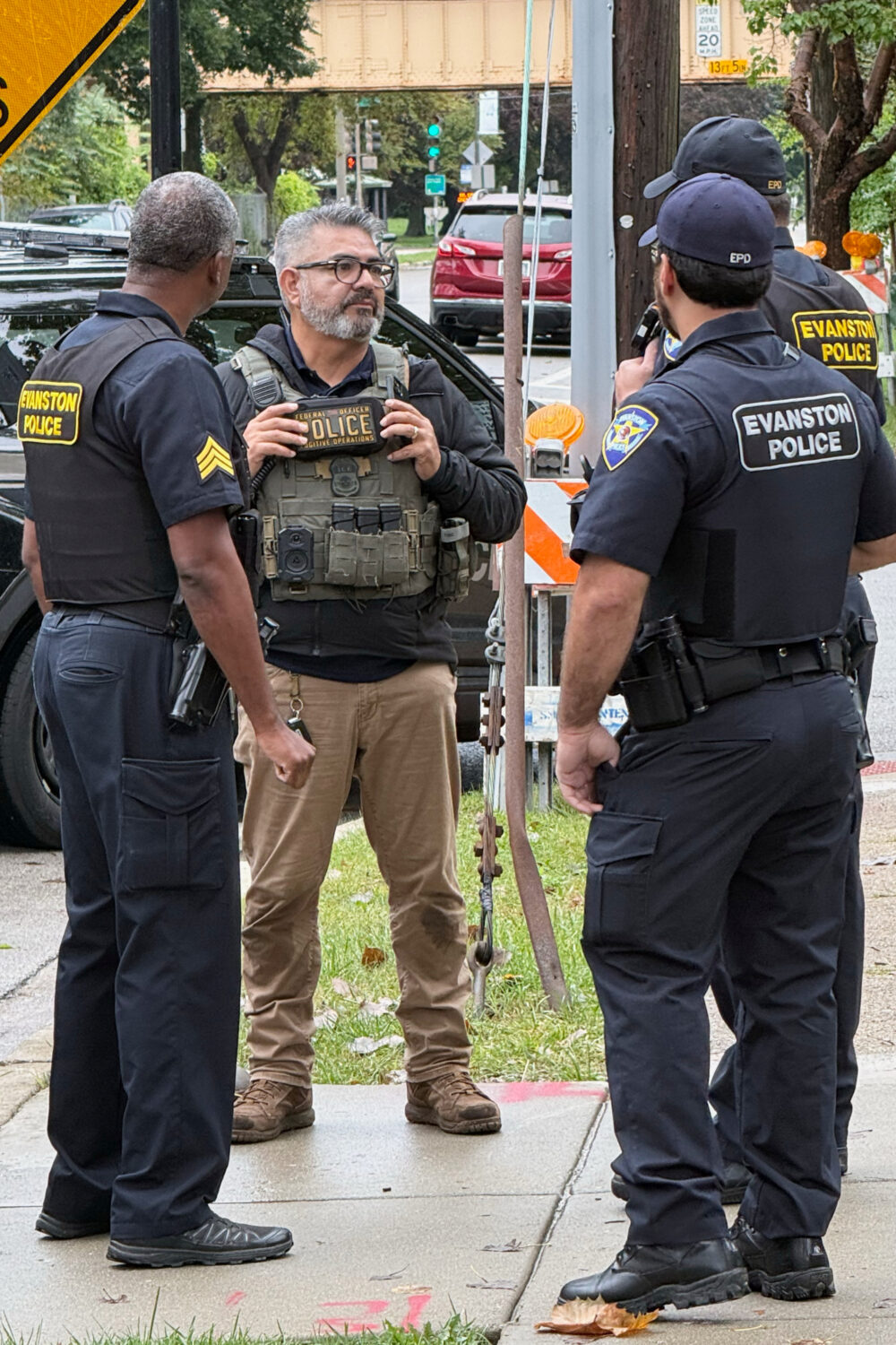 This photo taken with a smartphone and provided by Ryan Garton shows a federal officer speaking to ...