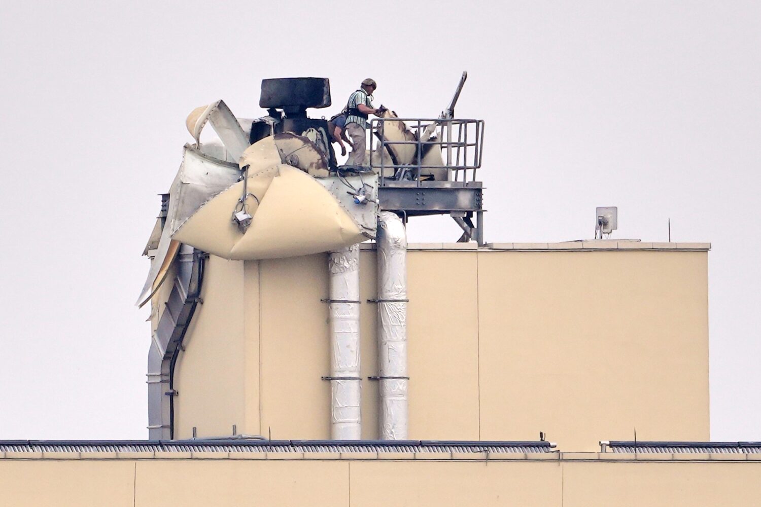 FILE - U.S. embassy personnel inspect the damage caused by a bombing in Baghdad, March 14, 2026. (A...