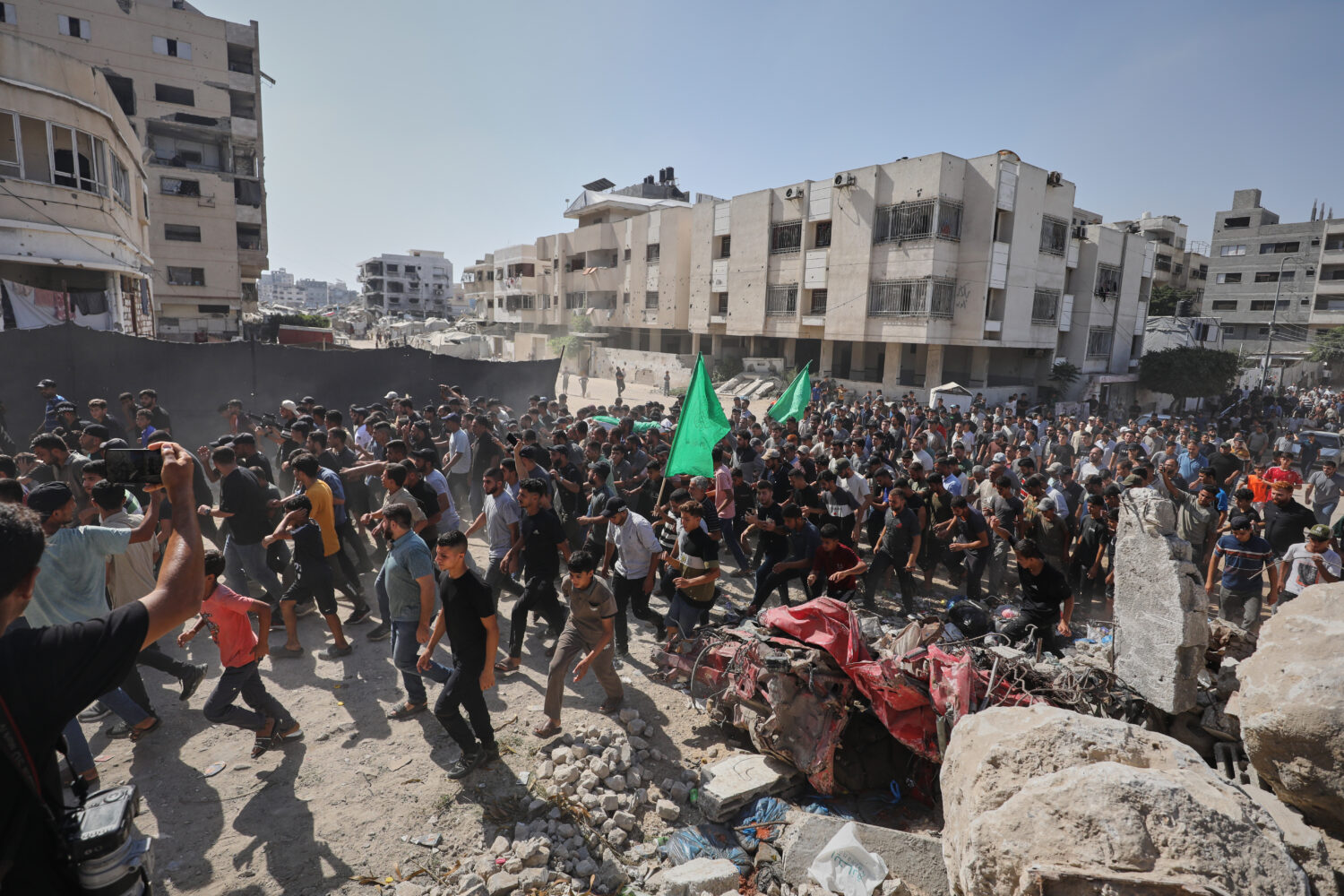 Palestinians carry the body of Ahmad Al-Batsh, a Qassam Brigades commander in Jabaliya, the militar...