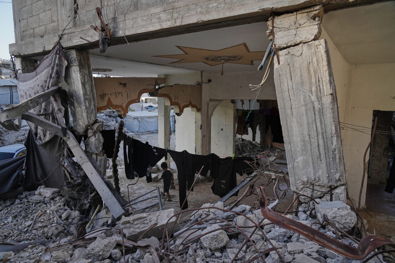 Displaced Palestinians shelter inside a building heavily damaged during the Israel-Hamas war in Gaz...