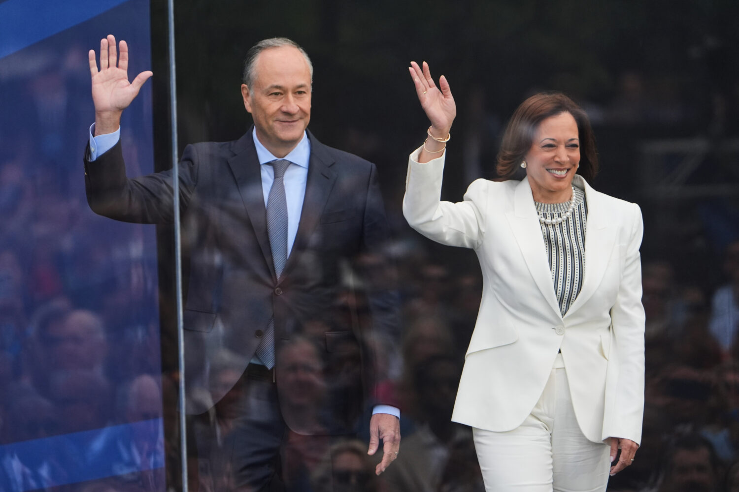 FILE - Former Vice President Kamala Harris and her husband Doug Emhoff arrive on stage during the d...