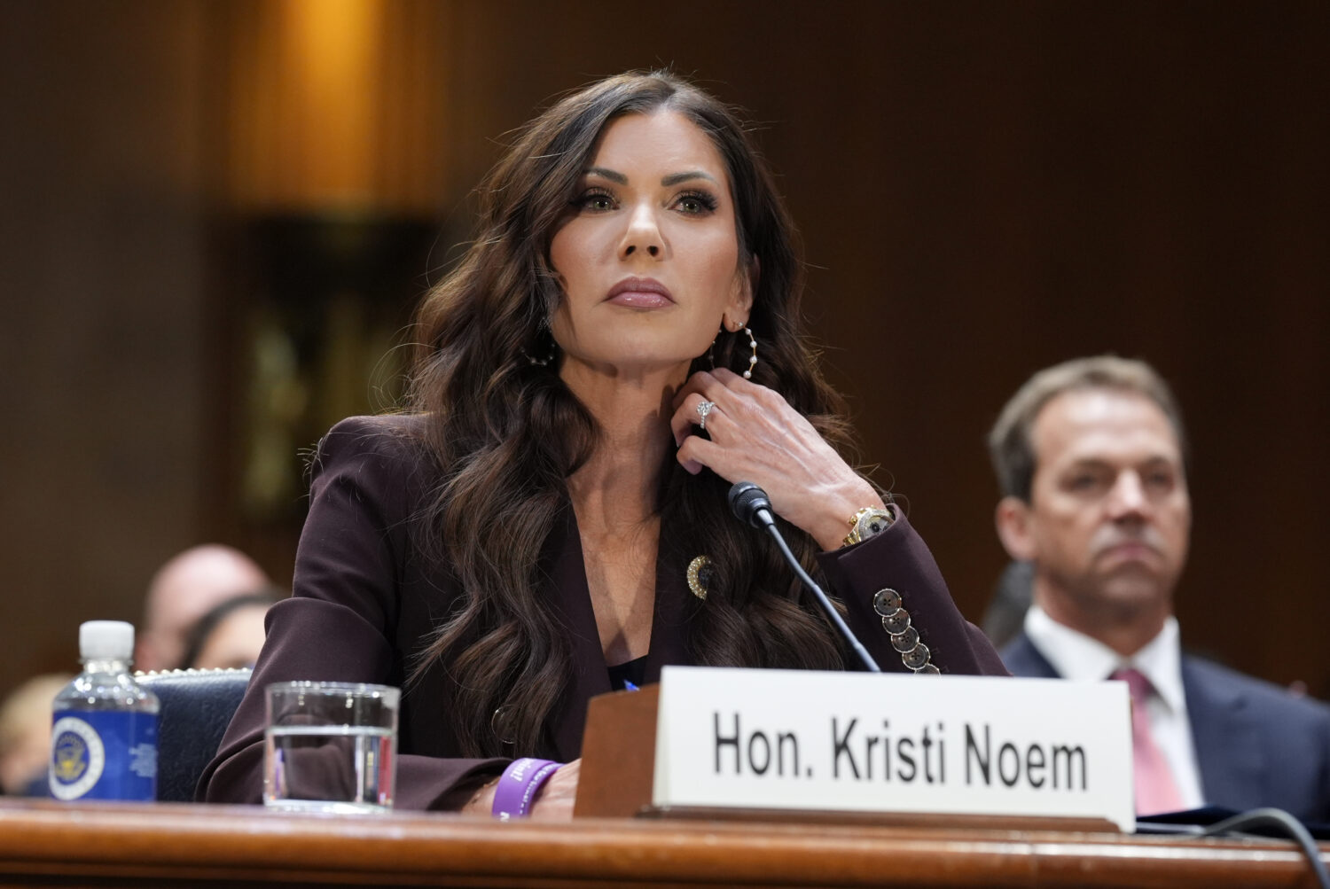 FILE - Homeland Security Secretary Kristi Noem, center, with her husband Bryon Noem, right, seated ...