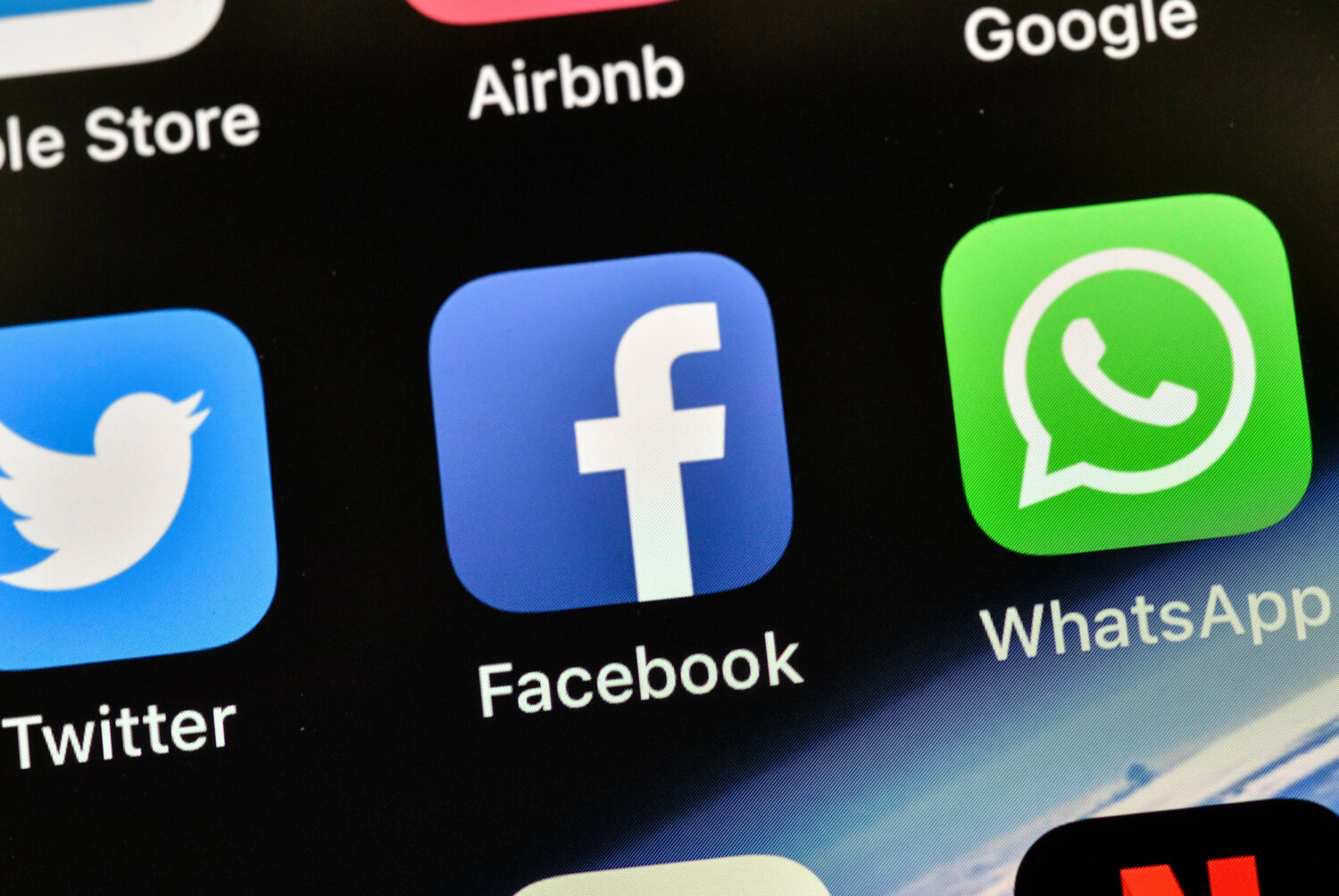 FILE - In this Thursday, Nov. 15, 2018 file photo the icons of Facebook and WhatsApp are pictured o...