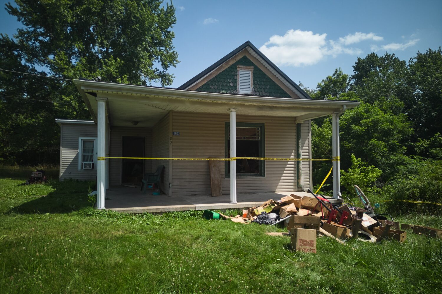 FILE - Police tape surrounds a home where authorities say they removed 16 children and arrested fou...