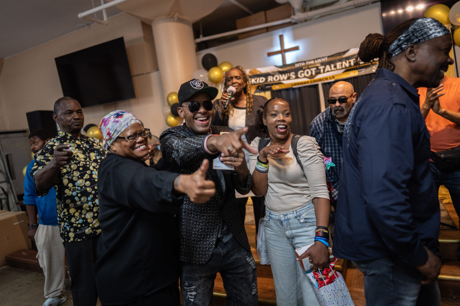 Winners, judges and volunteers celebrate after the winners are announced at the end of Skid Row's i...