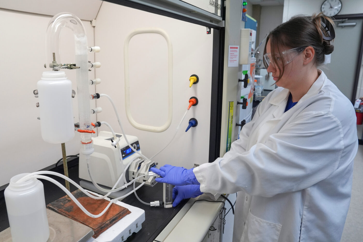 FILE - Stephanie Stoll starts a pump as part of an experiment studying the removal of PFAS from wat...