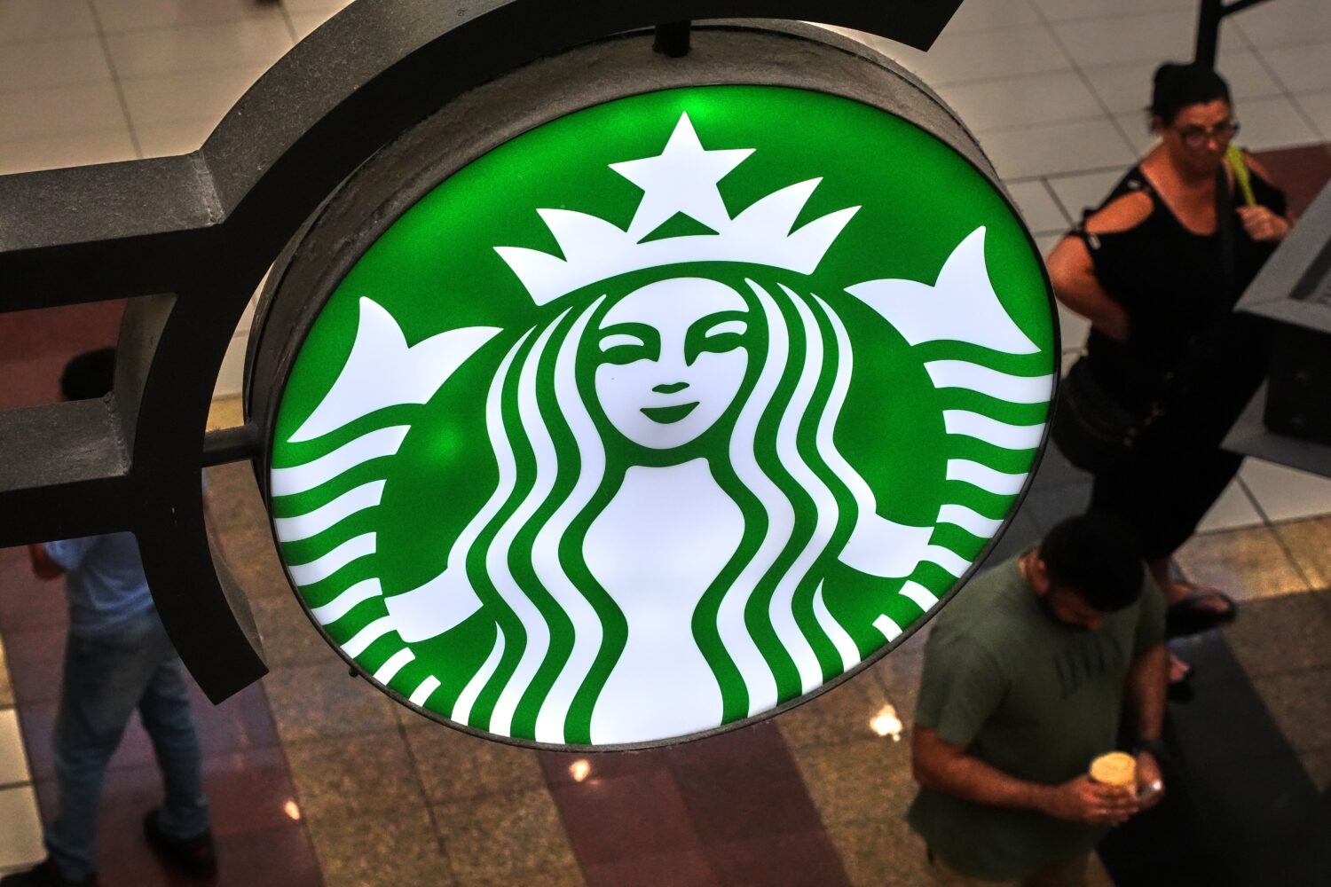 FILE - A Starbucks sign is displayed in the Galleria Mall in Buffalo, N.Y., Wednesday, Aug. 26, 202...