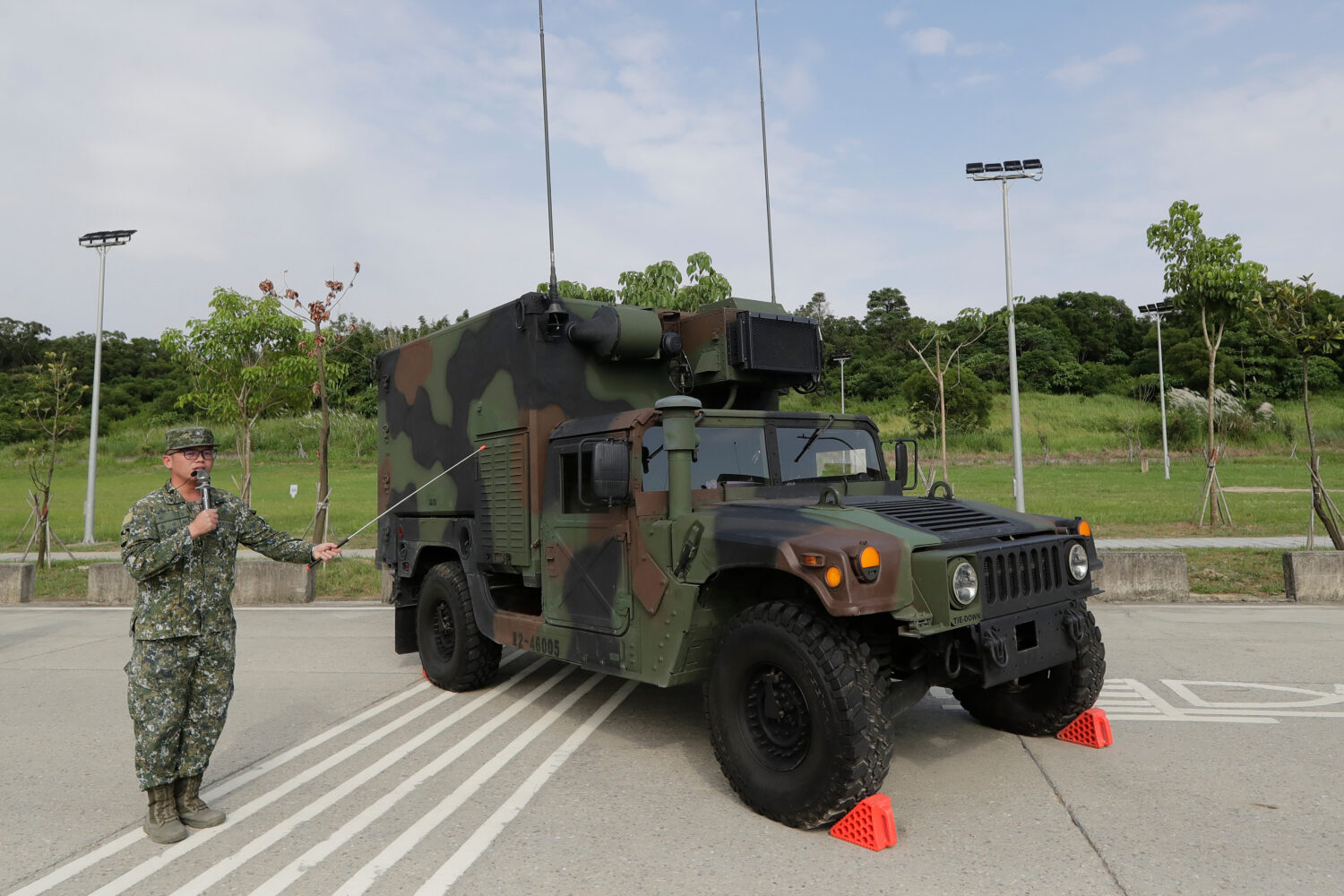 A soldier briefing a specialized HIMARS (M142 High Mobility Artillery Rocket System) command and co...