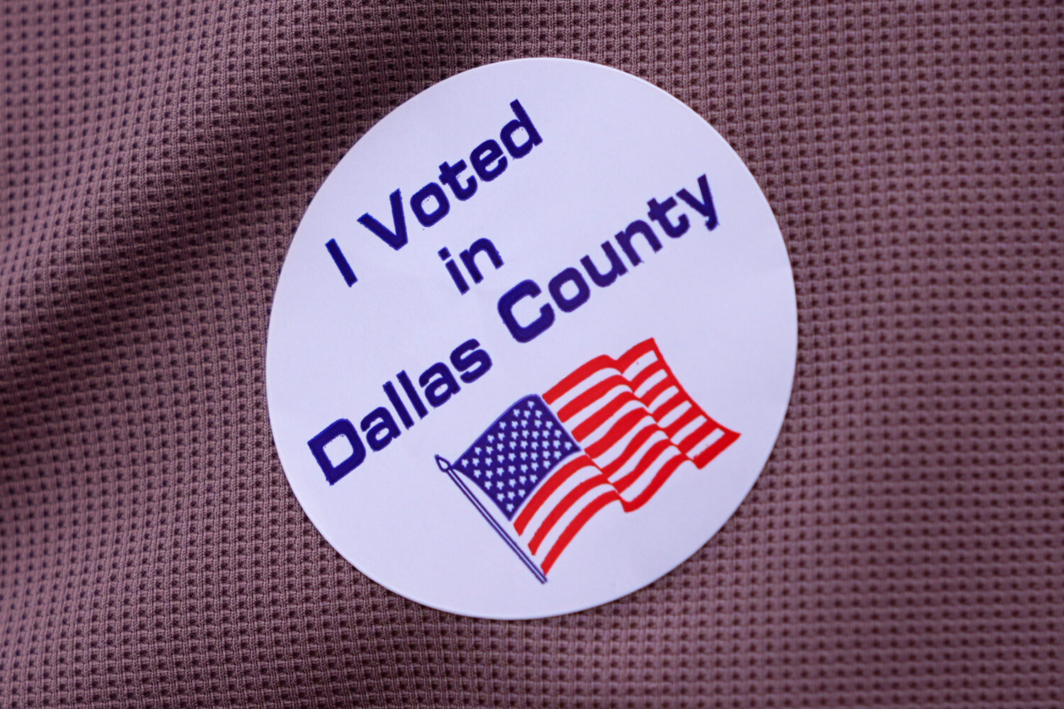 FILE - A primary voter wears a sticker after casting a ballot at a voting center in Dallas, Tuesday...