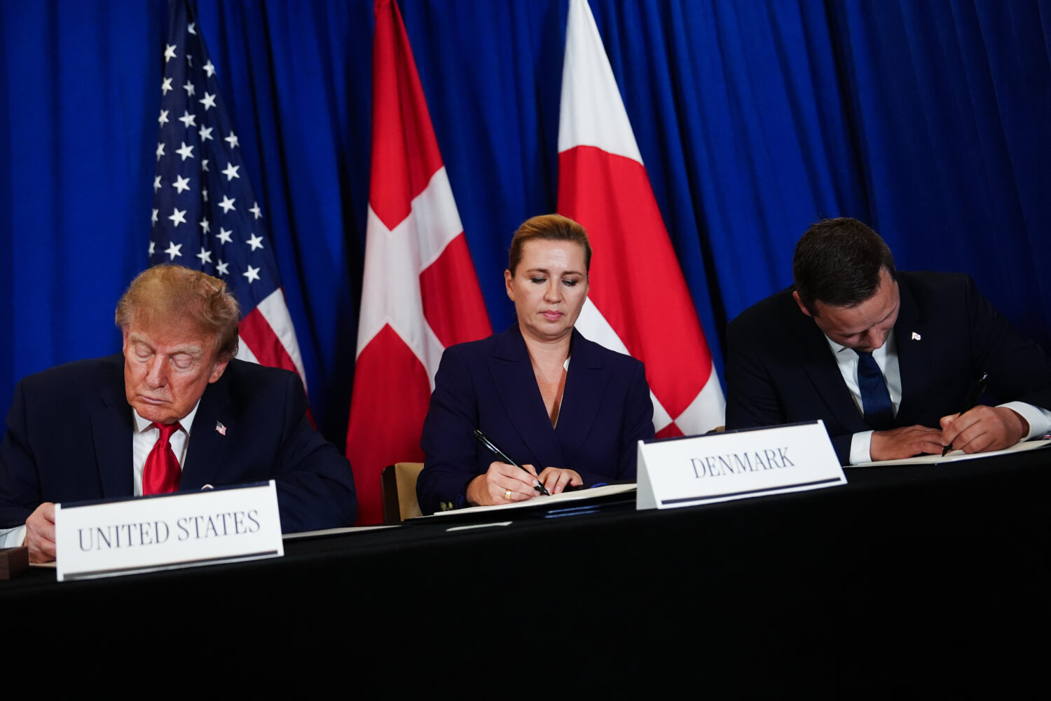 President Donald Trump signs a security agreement with Denmark's Prime Minister Mette Frederiksen a...