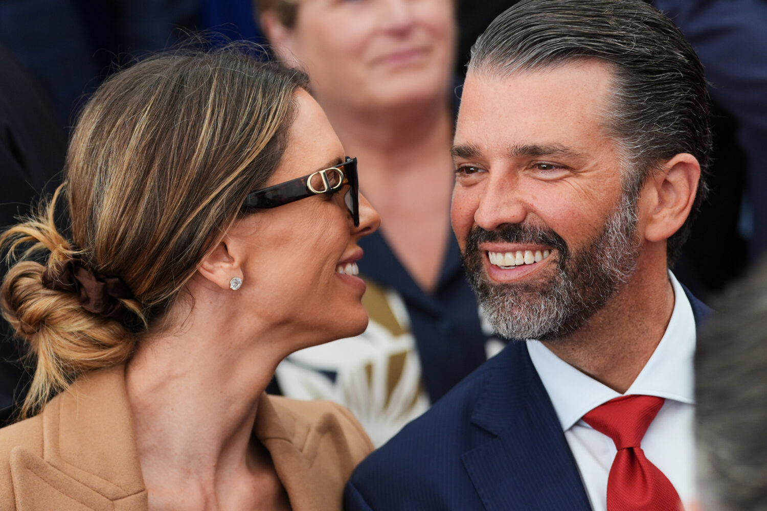 FILE - Donald Trump Jr., speaks with his wife Bettina, left, as they wait for President Donald Trum...