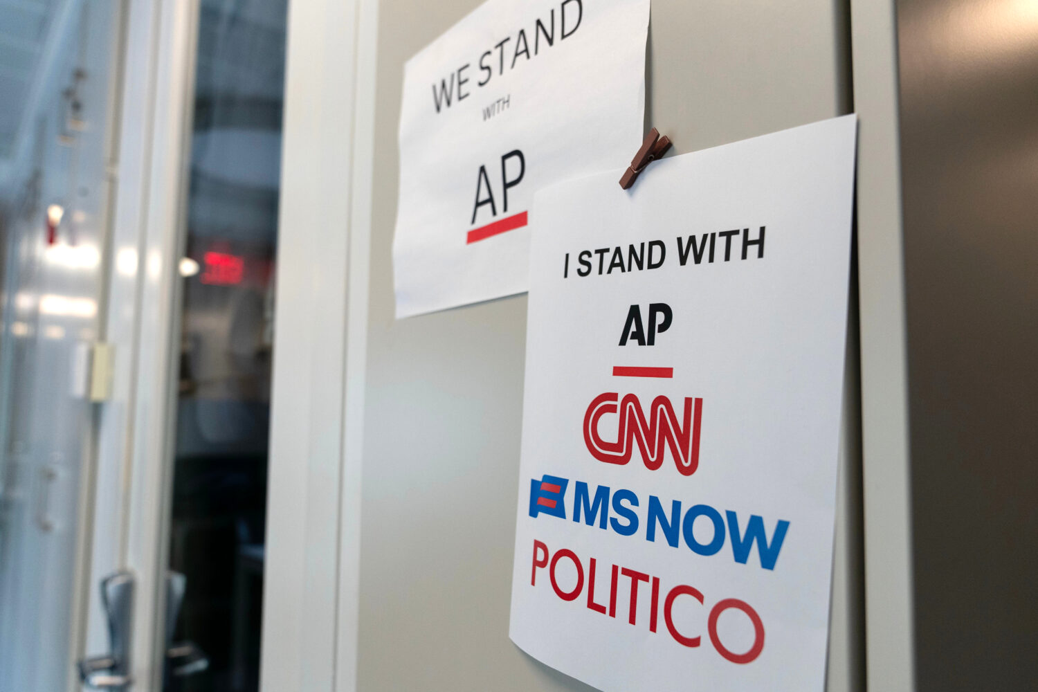 A sign in support of news outlets is seen at the White House press room, Sept. 19, 2026, in Washing...