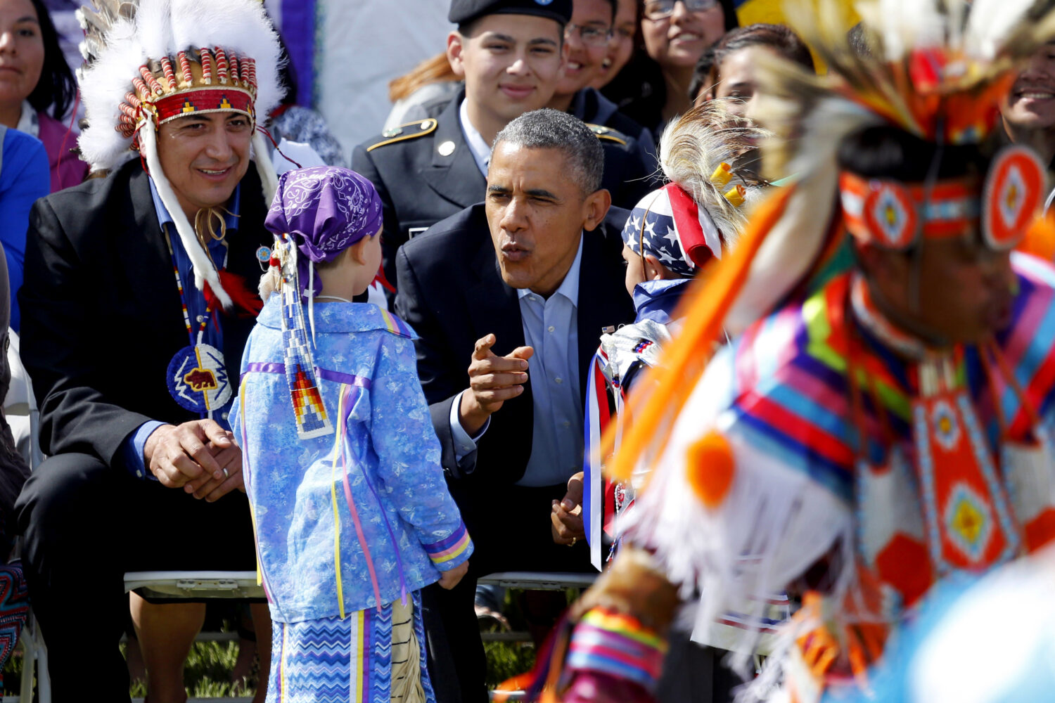 FILE - President Barack Obama talks to two young boys during a Native American dance on the Standin...