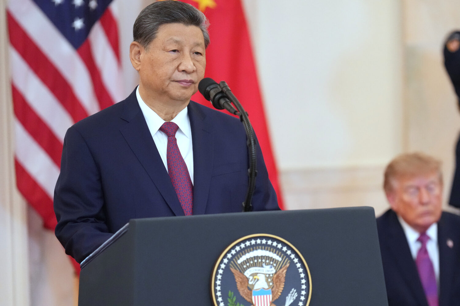 President Donald Trump listens as China's President Xi Jinping speaks during an arrival ceremony in...
