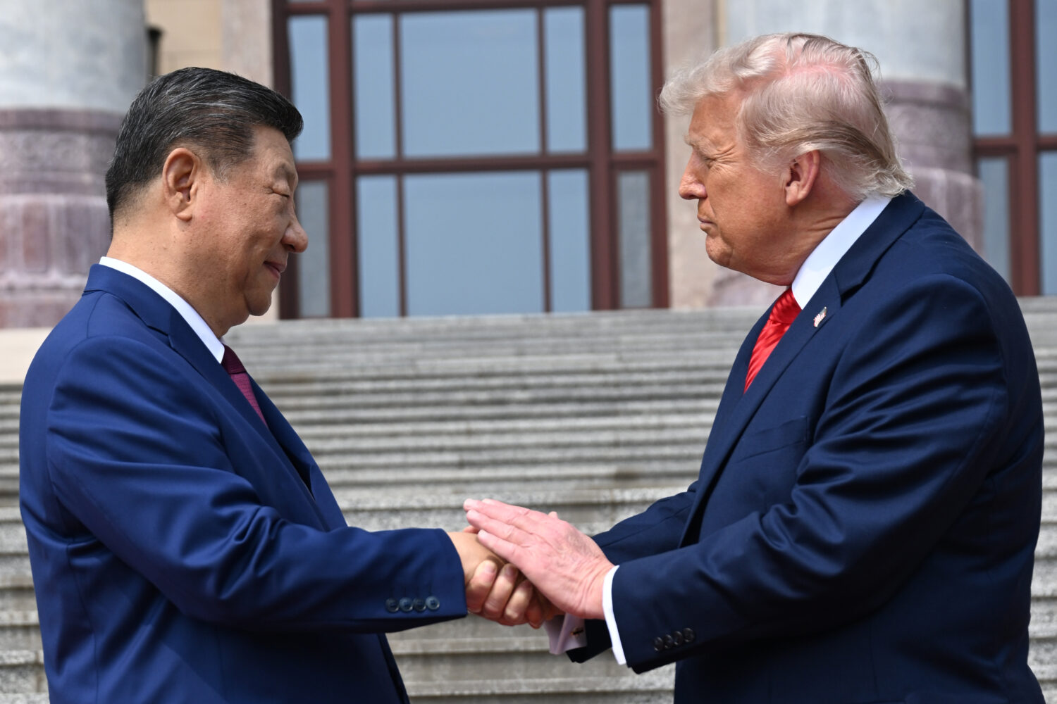 FILE - Chinese President Xi Jinping, left, shakes hands with President Donald Trump at the Great Ha...