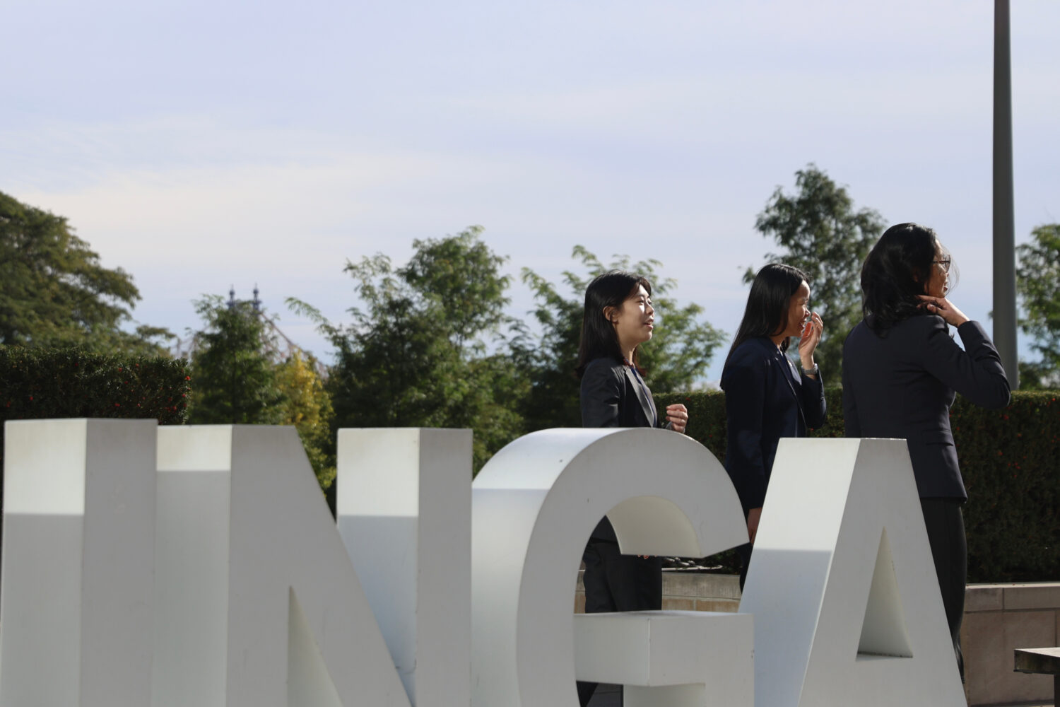 People pose for photos at United Nations headquarters during the 81st session of the United Nations...