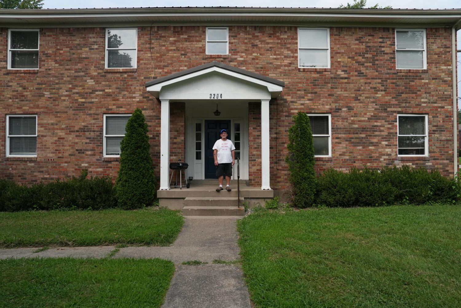 John Franklin poses for a portrait outside his permanent supportive apartment in Louisville, Ky., o...