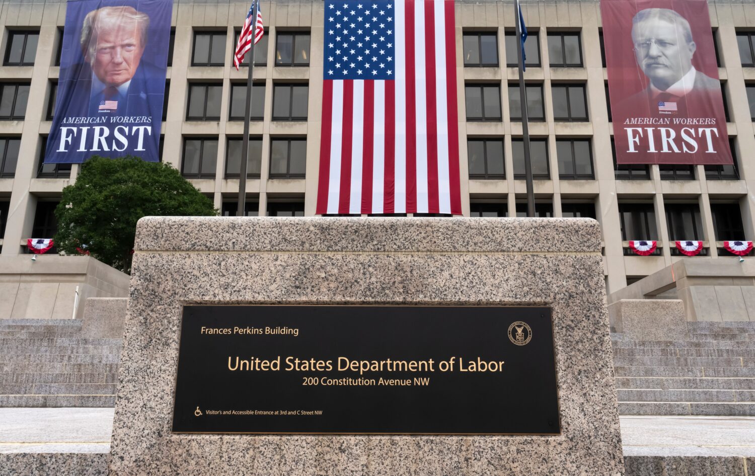 FILE - Portraits of Presidents Donald Trump and Theodore Roosevelt hang above the Department of Lab...