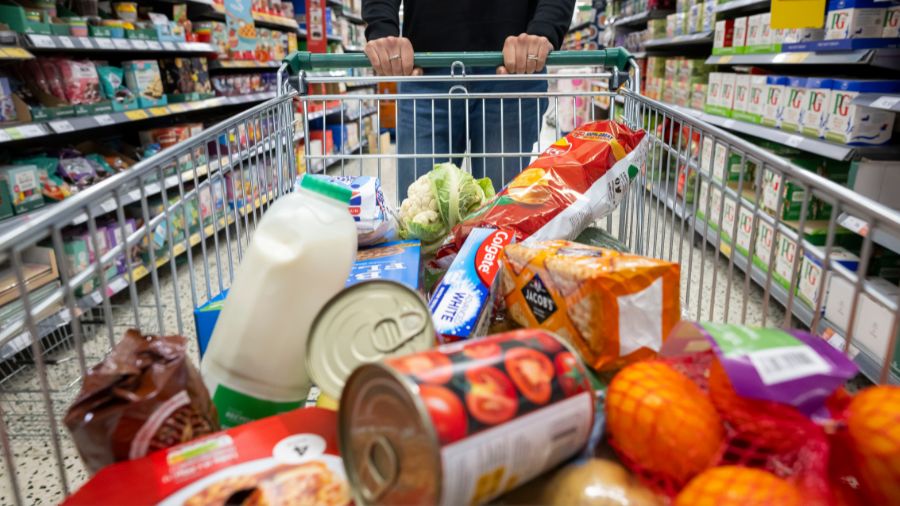 A person with a shopping cart full of groceries in a supermarket aisle. (Photo: Matthew Horwood, Ge...