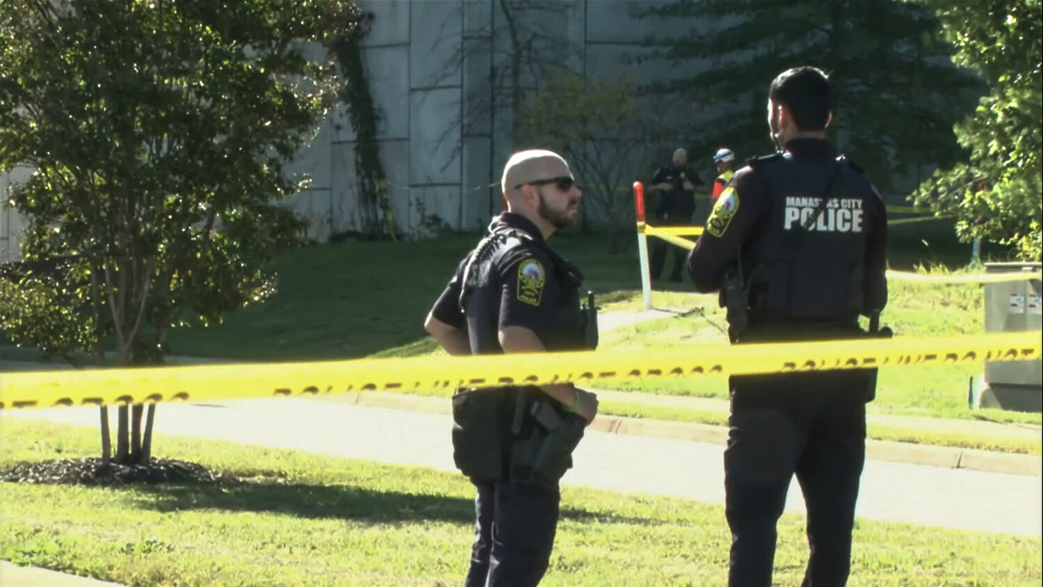 In this image from video provided by WJLA, police officers gather near the scene of a shooting in M...