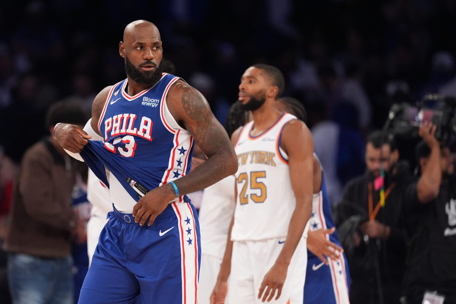 Philadelphia 76ers forward LeBron James, left, passes New York Knicks guard Mikal Bridges after the...