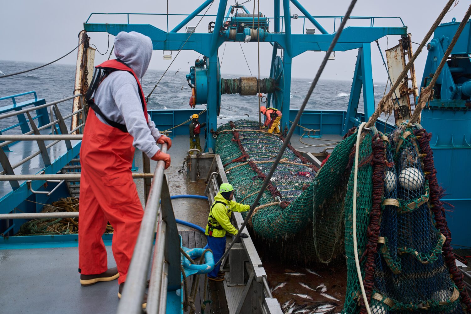 Crew members haul in a catch aboard the F/V Progress in the Bering Sea off the coast of Alaska, Wed...