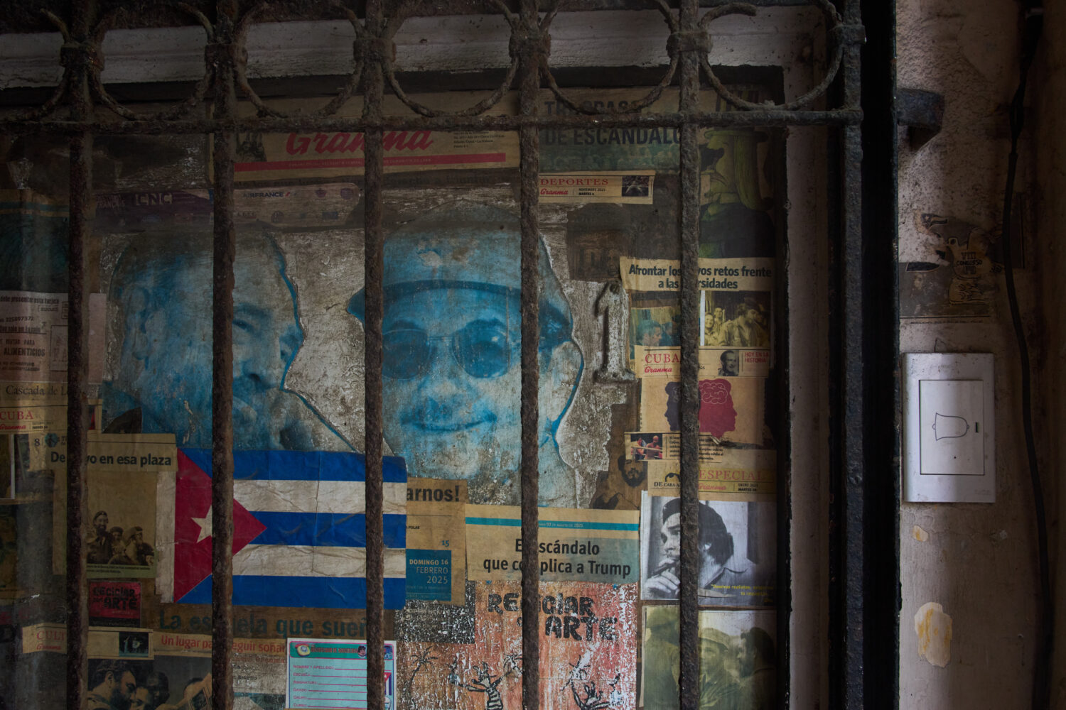 Photos of former Presidents Raúl Castro, right, and his late brother Fidel Castro cover a front do...