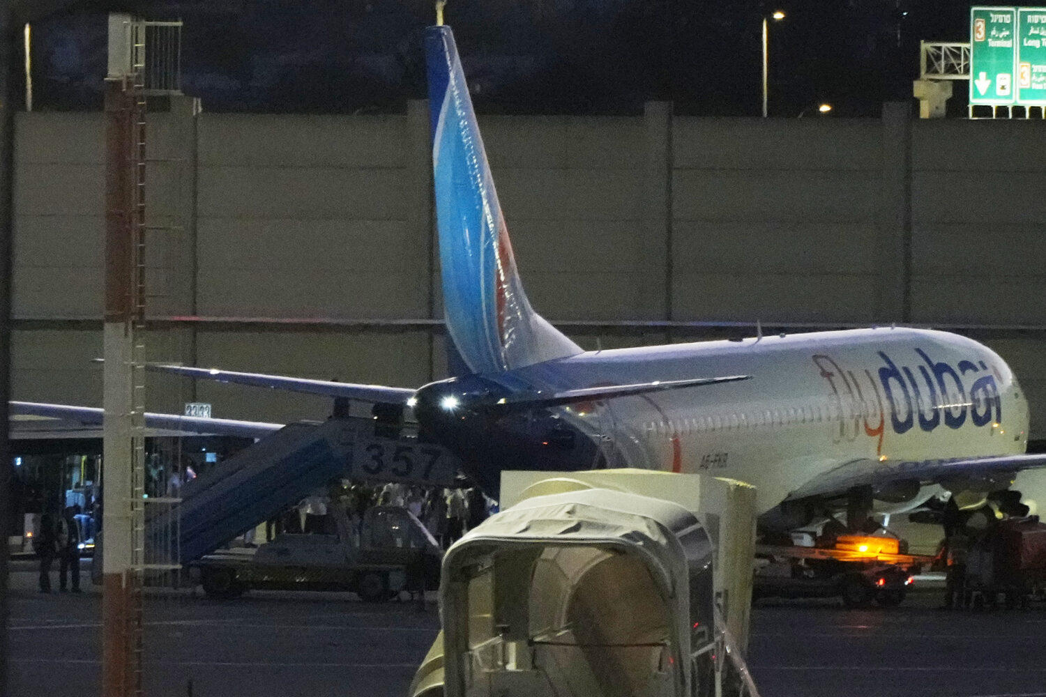 People disembark from a FlyDubai carrying Israeli passengers who had earlier been aboard another Fl...