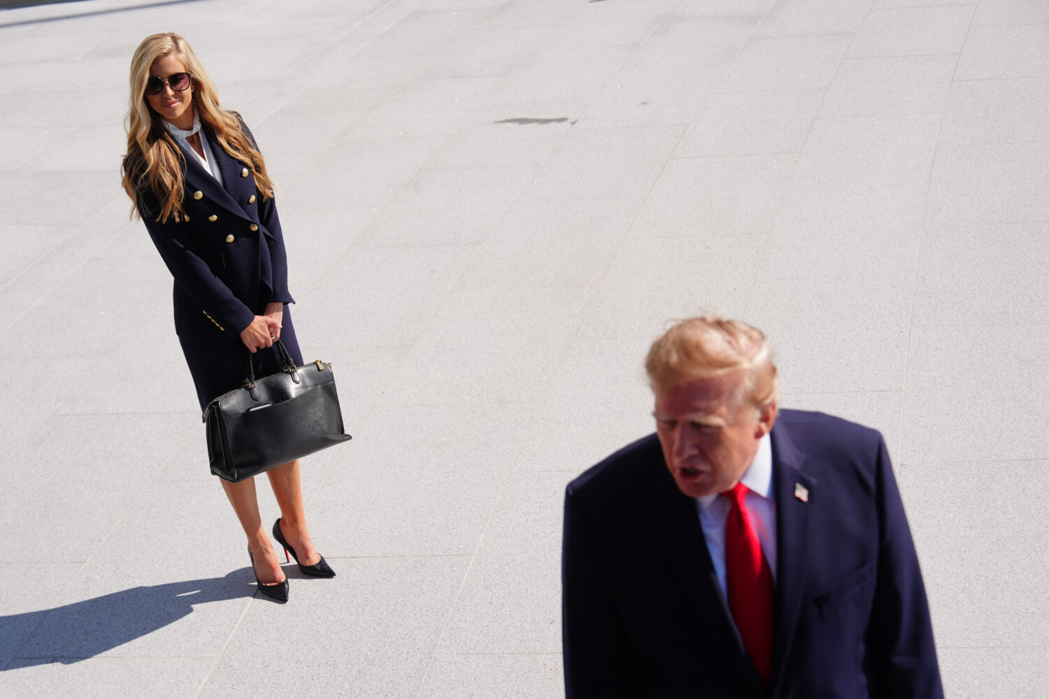 President Donald Trump speaks to the reporters as he walks to board Marine One on the South Lawn of...