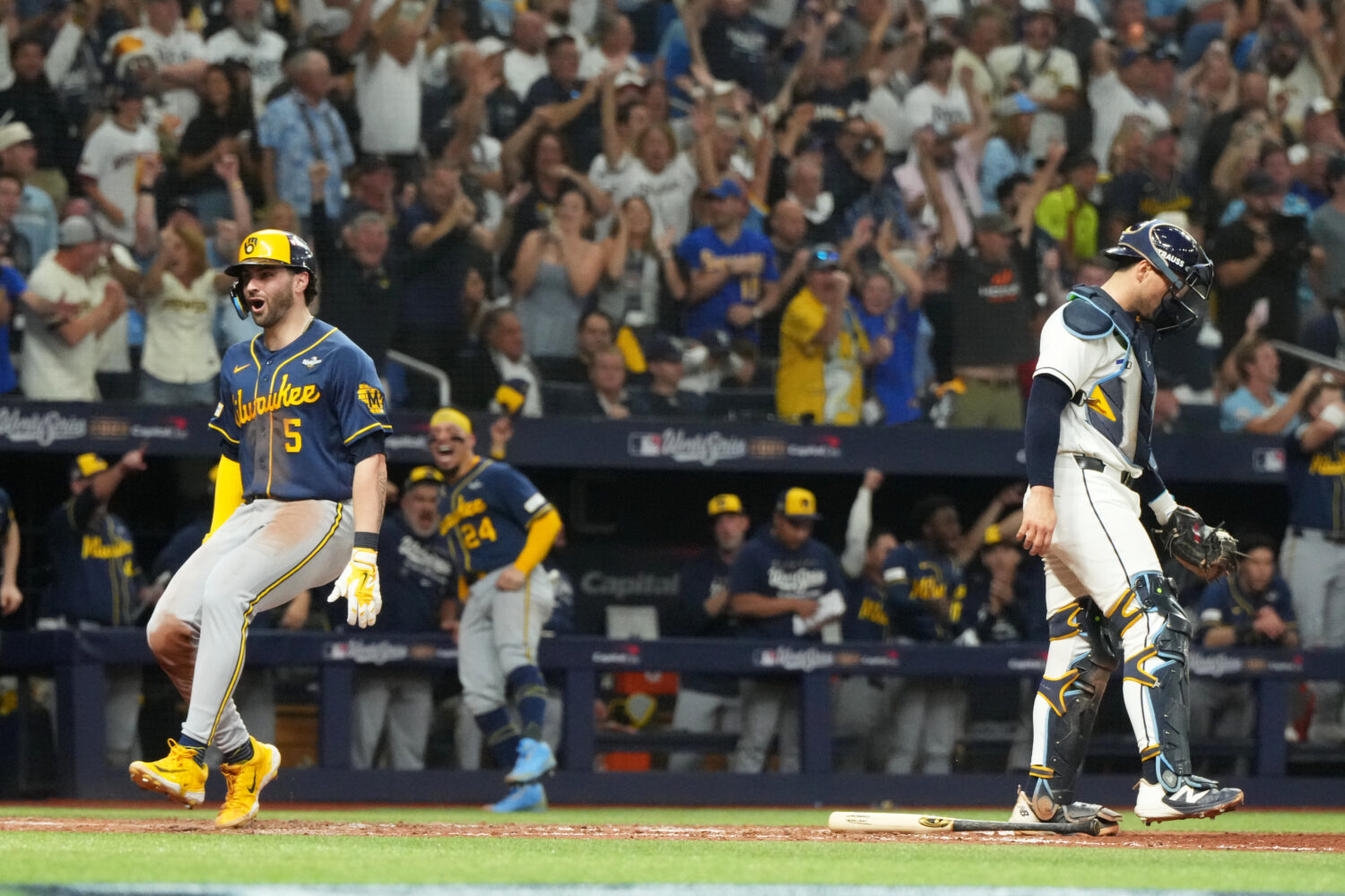 Milwaukee Brewers' Garrett Mitchell, left, celebrates past Tampa Bay Rays catcher Nick Fortes after...