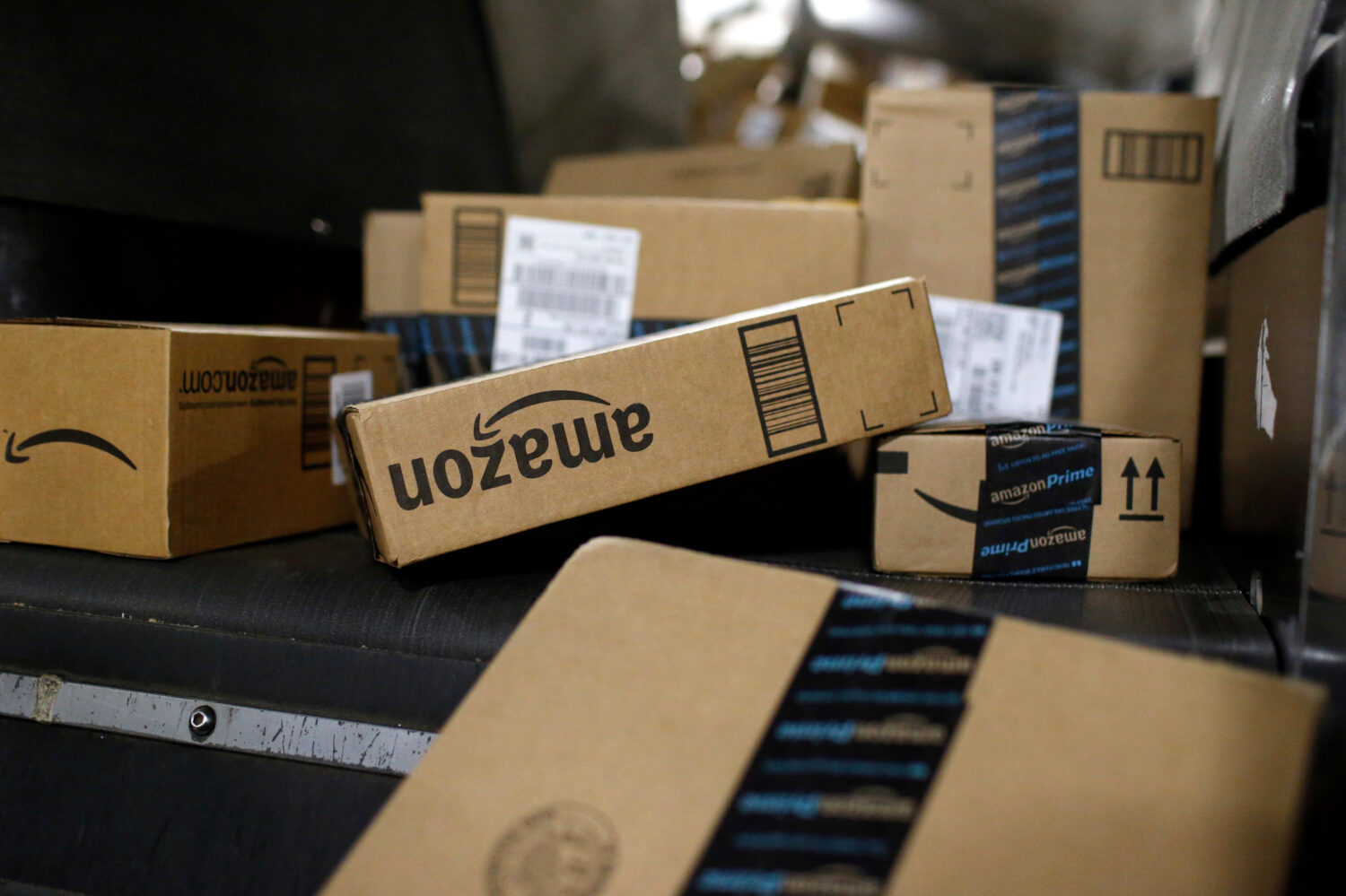 FILE - Packages in Amazon boxes move along a conveyor belt at the UPS Worldport hub in Louisville, ...