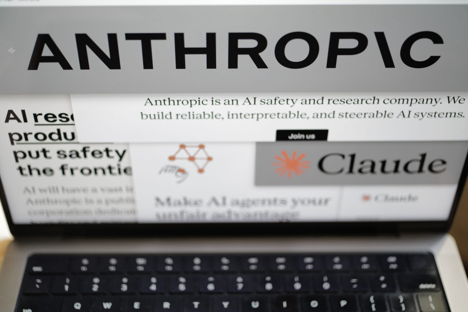 FILE - Pages from the Anthropic website and the company's logos are displayed on a computer screen ...