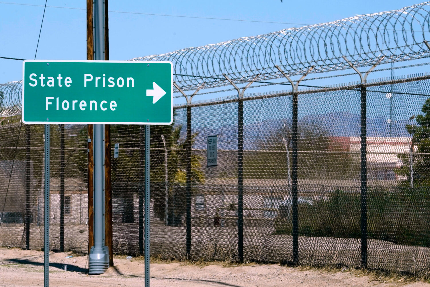 FILE - A sign points in the direction of the Arizona State Prison in Florence, Ariz., March 19, 202...