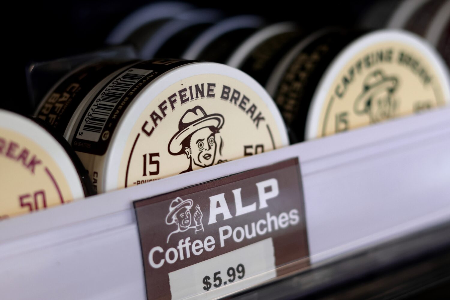 Containers of caffeine pouches, small packets placed in the mouth between the lip and gum, are on d...