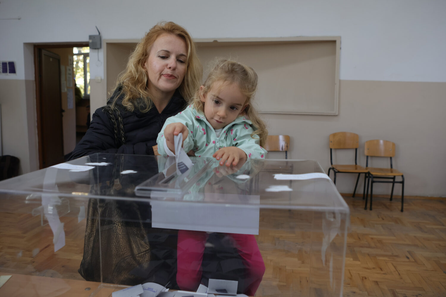 A woman with a child casts her vote in Sofia, Bulgaria, Sunday, Oct. 25, 2026, during the President...