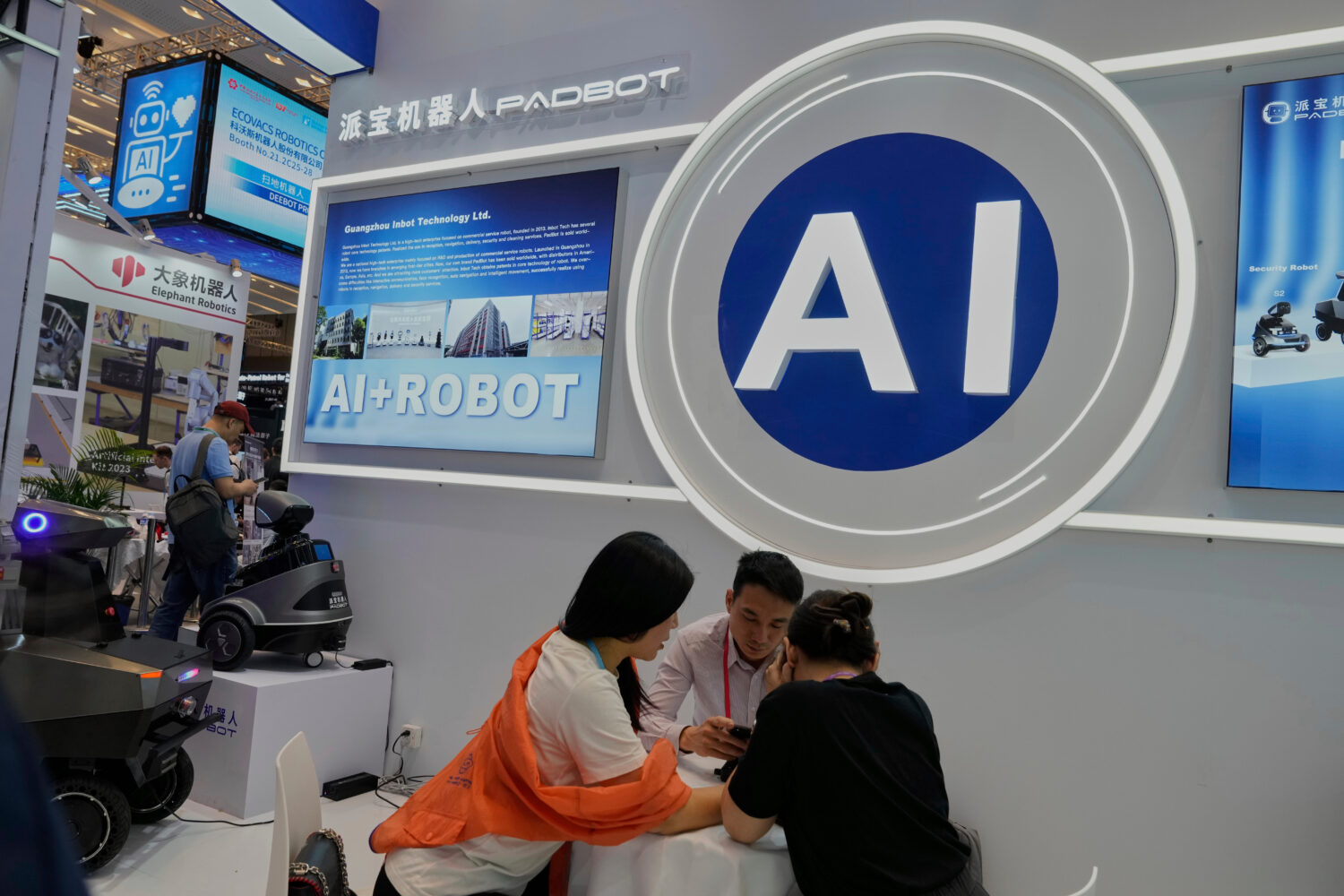 FILE -Vendors for AI enabled robots wait for customers at the 137th Canton Fair in Guangzhou in sou...