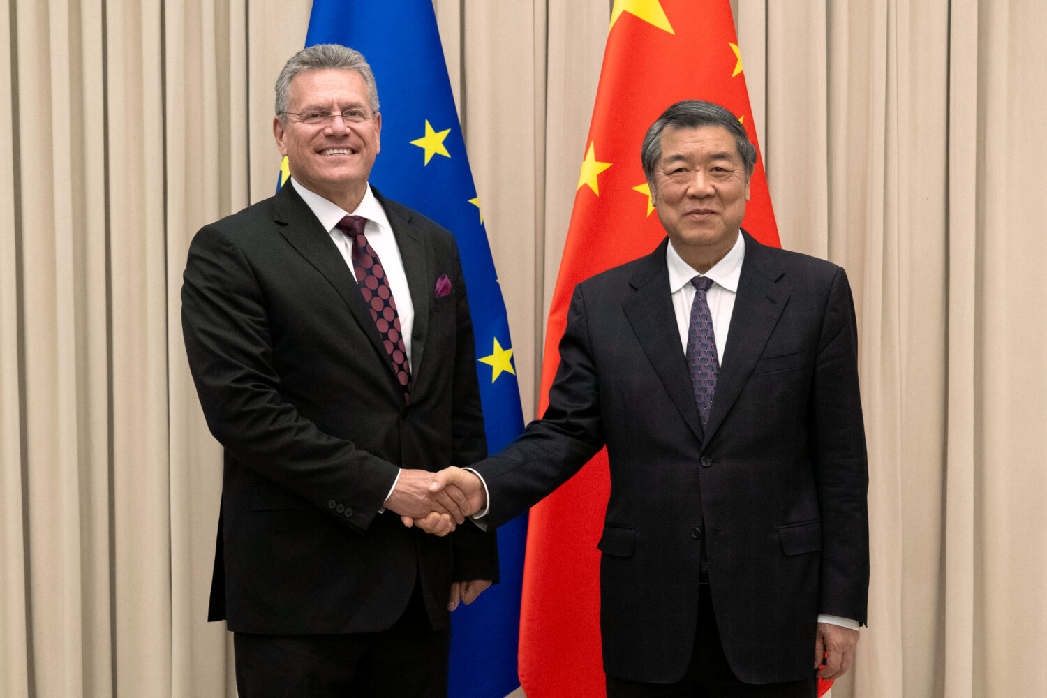 In this photo released by the Xinhua News Agency, Chinese Vice Premier He Lifeng, right, shakes han...