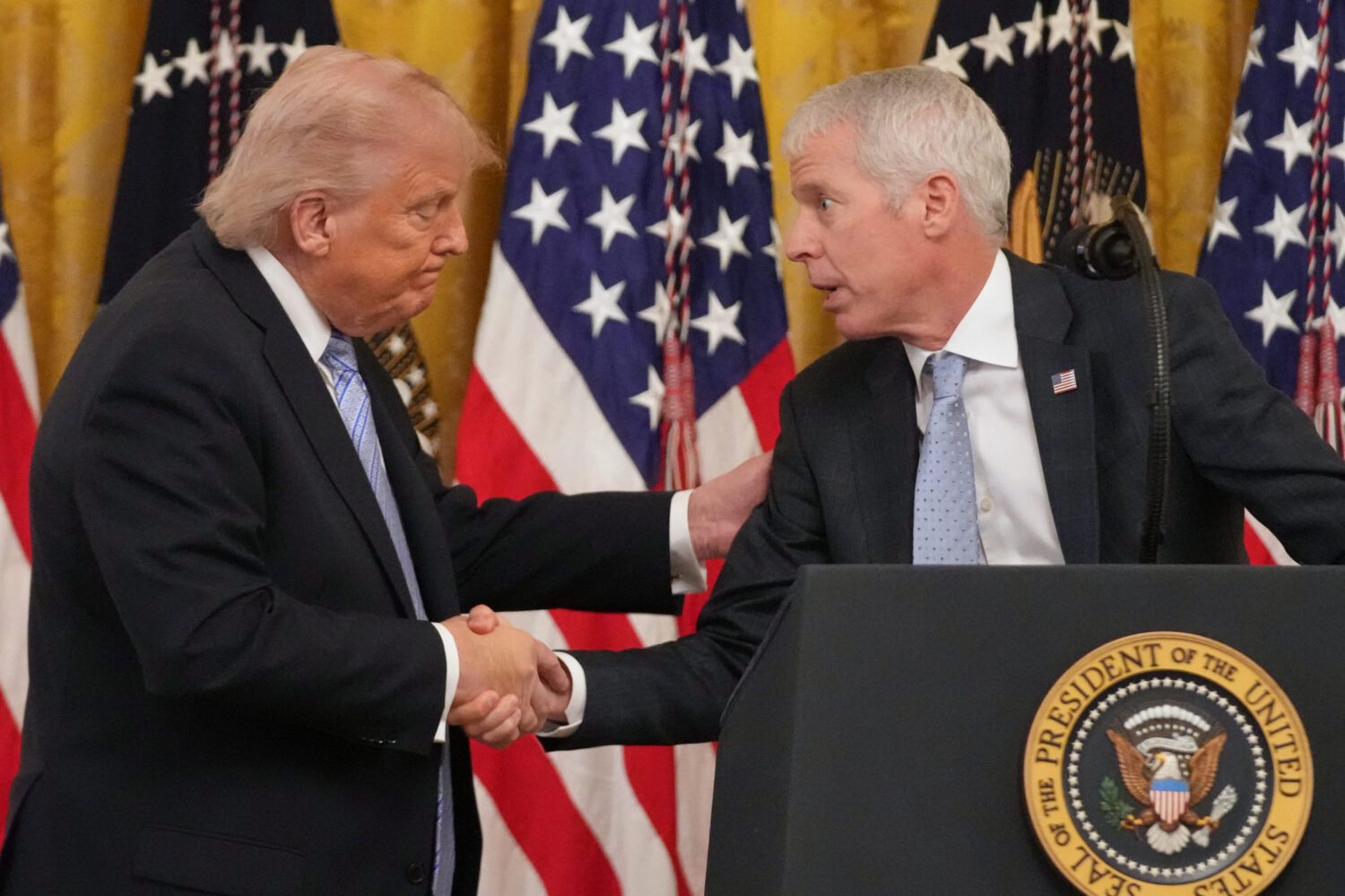 FILE - President Donald Trump shakes hands with Energy Secretary Chris Wright, right, during an eve...