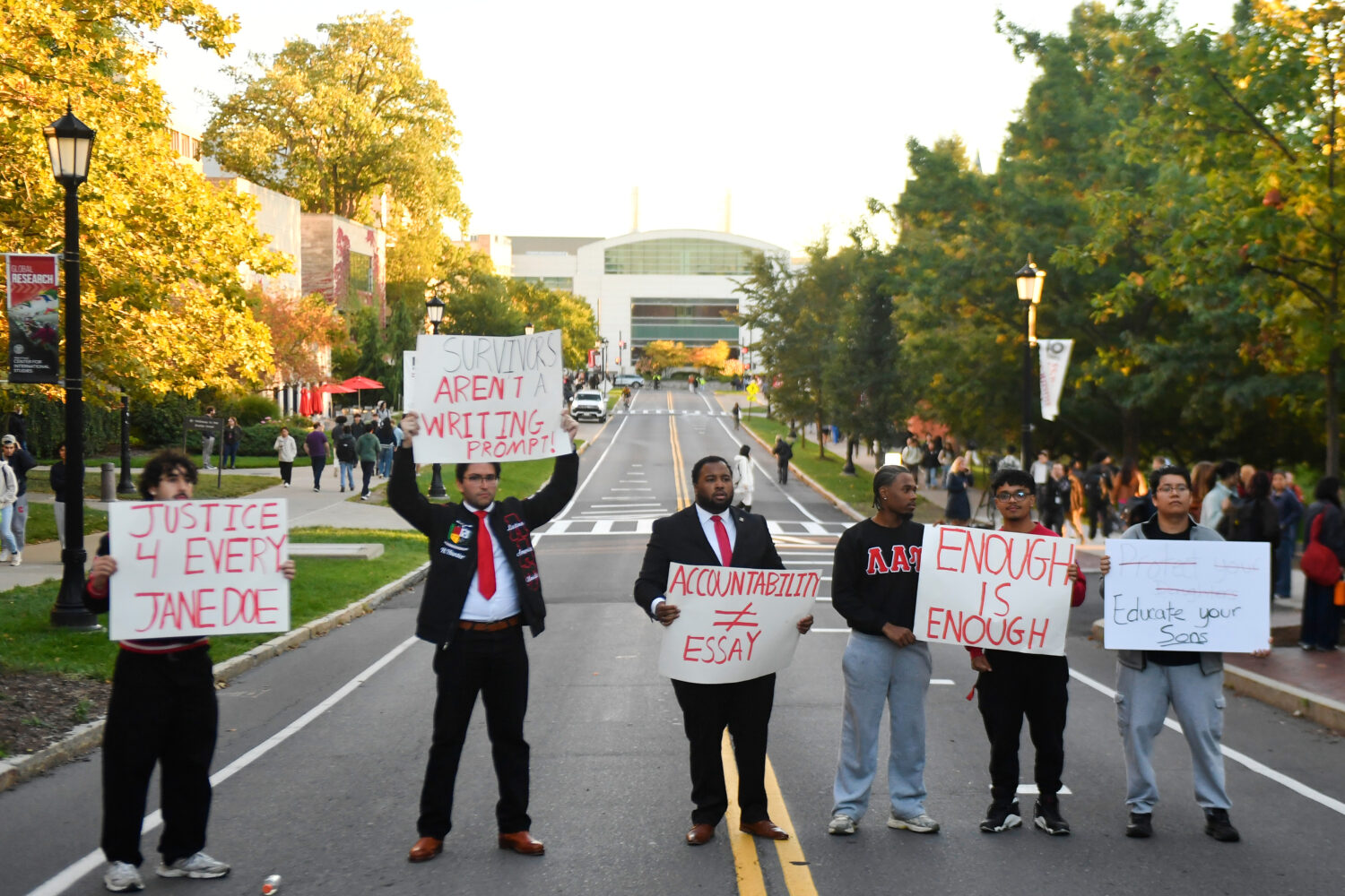 Demonstrators hold signs during a protest against Cornell University's handling of the 2024 fratern...