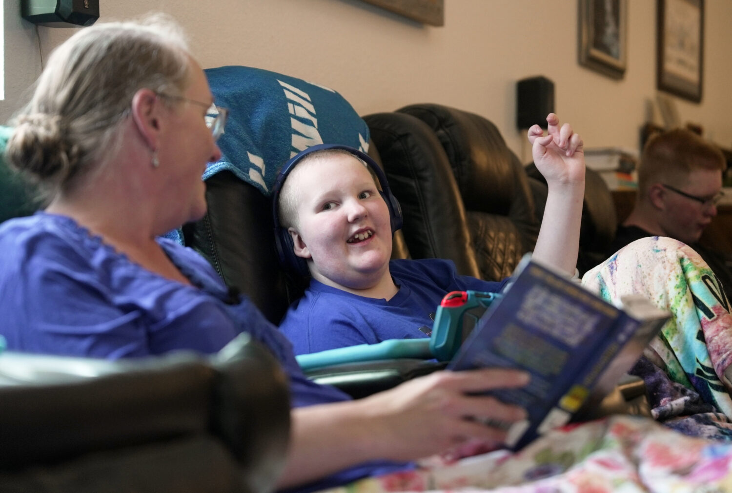 William Walter, 11, and his mother, Katherine, read a book together during homeschooling hours in W...