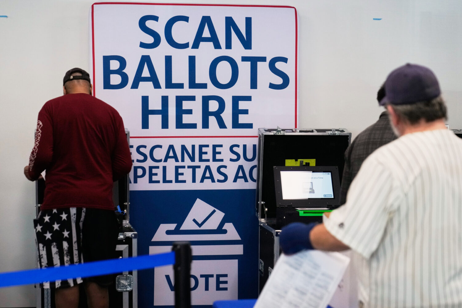 Voters scan their ballots at early in-person voting in Cleveland, Wednesday, Oct. 7, 2026. (AP Phot...